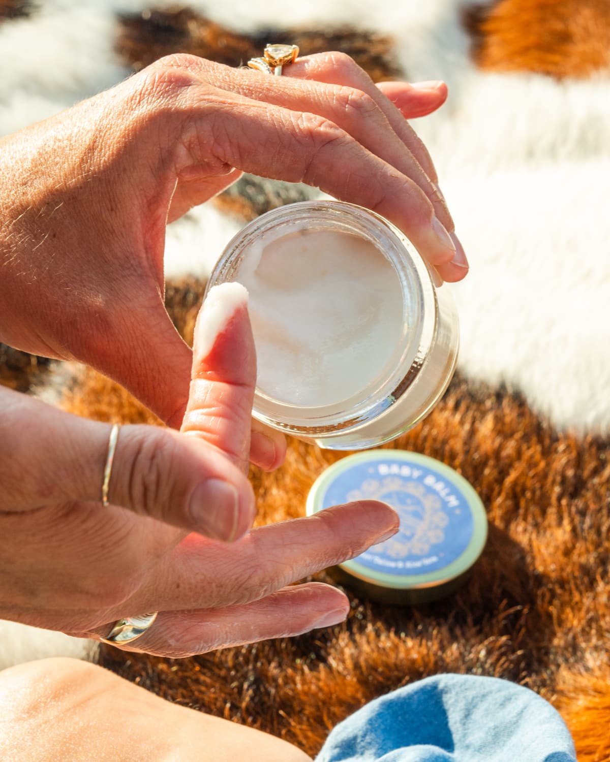 A finger dipping into a jar of Western Provisions tallow balm