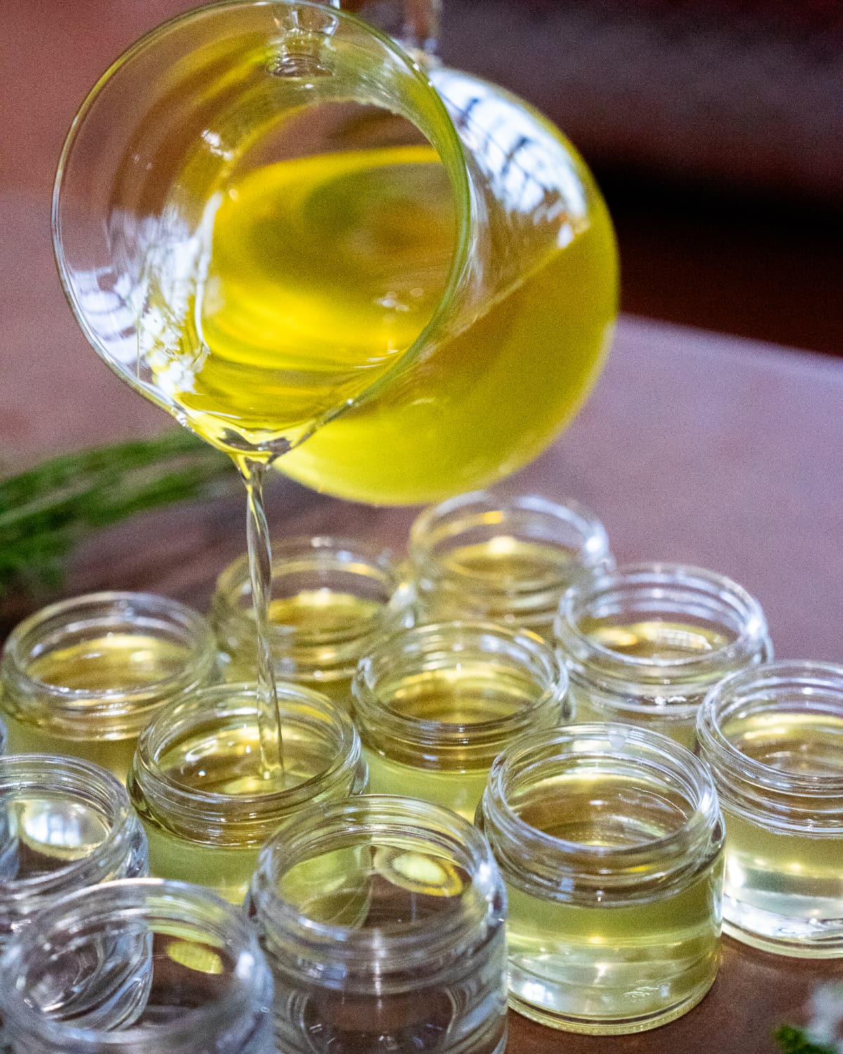 Pouring liquid tallow balm into jars for Western Provisions